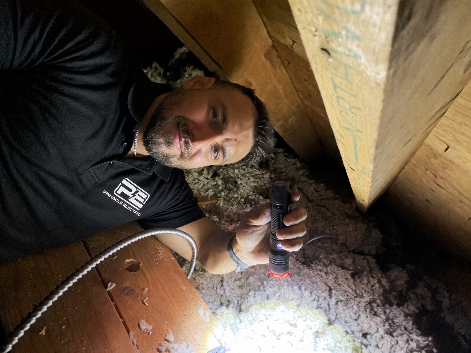 Ivan Iniguez checking an attic